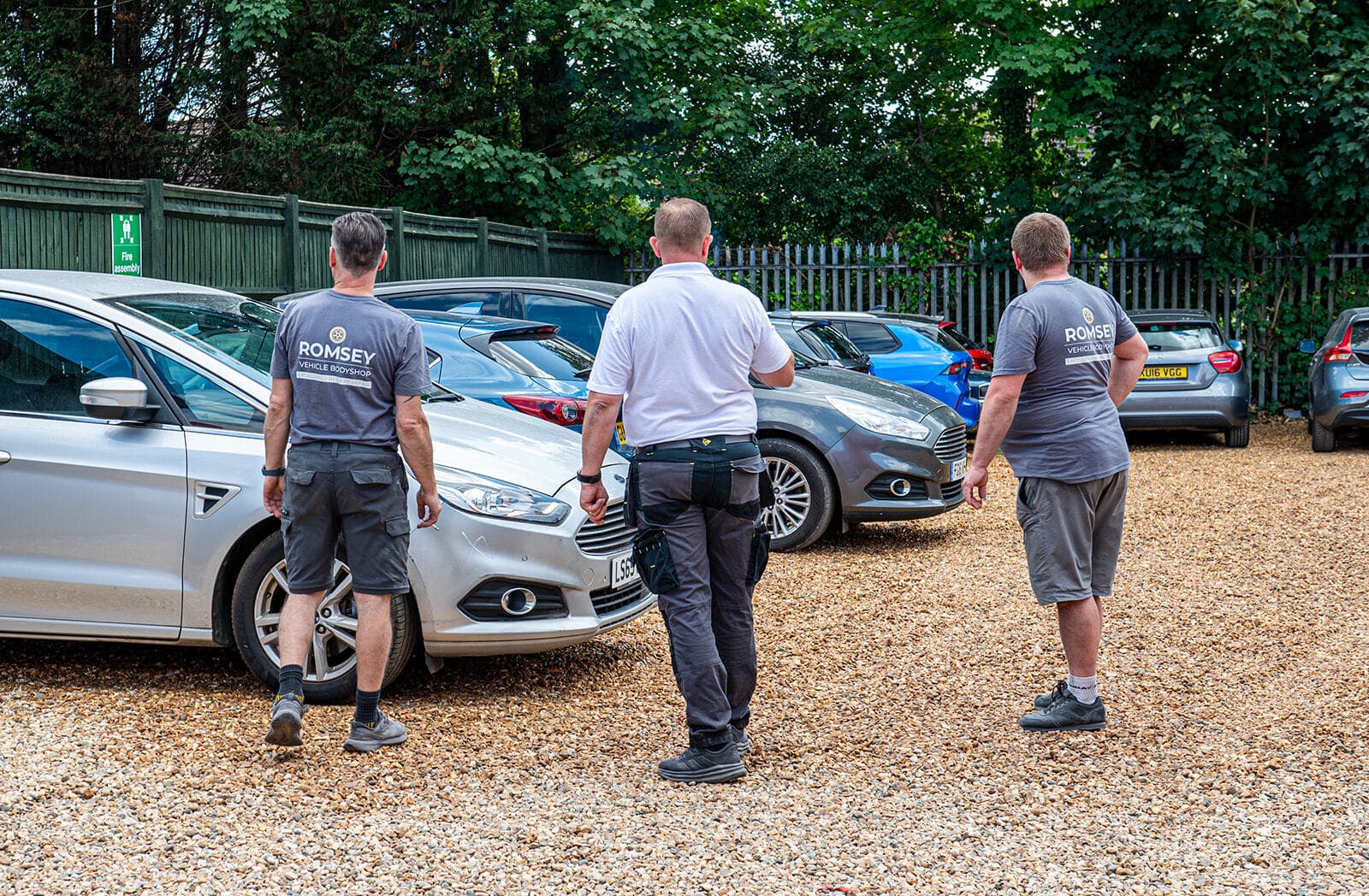 Technician working on car in spray booth